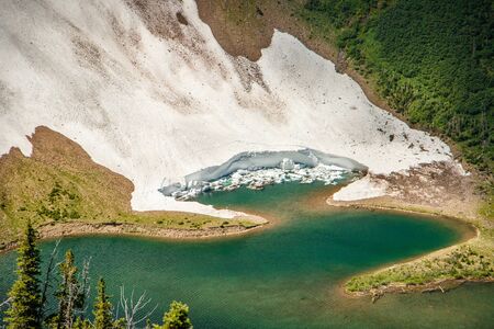 Detail of the glacier falling down into a lake at Acamina ridge Trail, Waterton Lakes NP, Canadaの写真素材