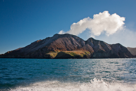 White Island in North Island of New Zealand, Aotearoa as maori name of country in Australasia, volcanic island with sulphur smoke, geologically young land, boat trip to island, natural wonderの写真素材