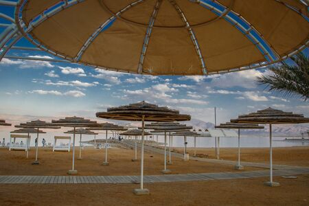 Hotel resort and touristic beach in Neve Zohar by Dead sea in Israel, salty water as healing stone...