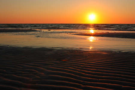 Sandy waves with sunset on Florida beach, US road trip, american dreamの写真素材