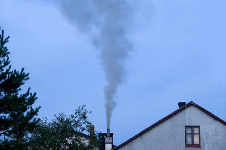 Ecology problems. Chimney emitting air pollution due to improper burn of solid fuelsの写真素材