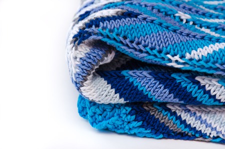 Folded knitted cotton sweater with zigzag pattern on white background. Handmade conceptの写真素材