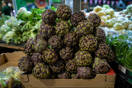 A colorful display of fresh artichokes awaits buyers in a market.の写真素材