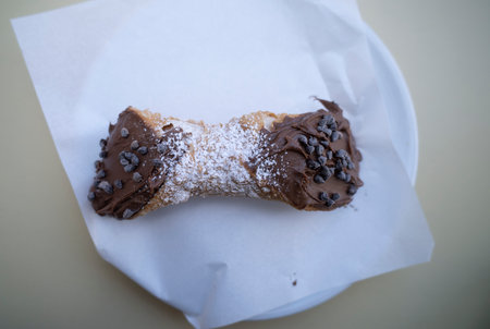 Delicious chocolate-filled pastry served on a white plate in a cafÃ©の写真素材