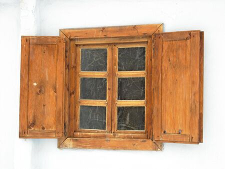 Old wood window with shutters on old building