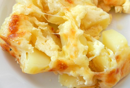 Close-up of delicious baked potatoes with cheeseの写真素材