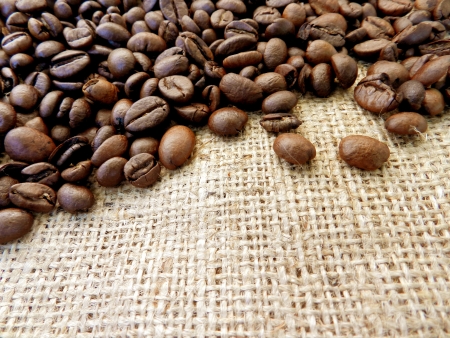 Coffee beans on the background of tissue/dark brown coffeeの写真素材