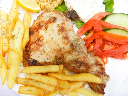 Grilled steak, french fries and vegetablesの写真素材
