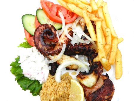 Grilled octopus with  french fries, tomatoes,rice and tzatziki の写真素材