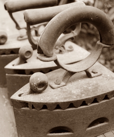 Old charcoal ironsの写真素材