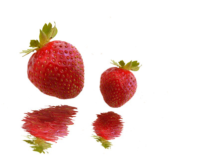 Strawberries falling in waterの写真素材