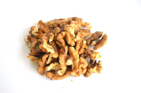 Stack walnut pieces and halves on a white background