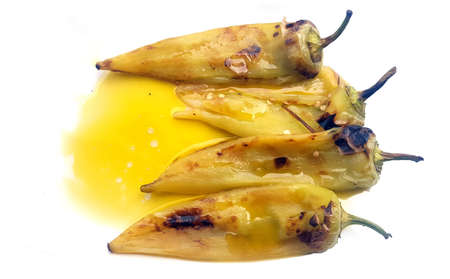 Grilled green sweet peppers with olive oil on white backgroundの写真素材