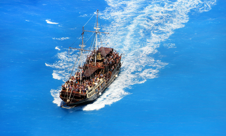 Pirate style boat ship in the ionian sea blue water, near famous Navagio beach, on  Zakynthos island, Greeceの写真素材