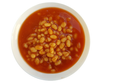Baked beans in tomato sauce on plate over white backgroundの写真素材
