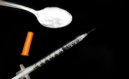 Drug syringe and cooked heroin on spoonの写真素材