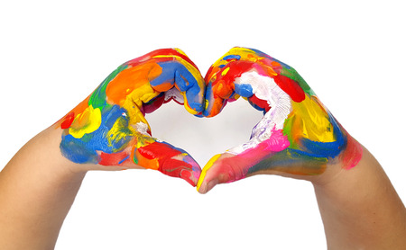 Heart shape made from kids painted hands on white backgroundの写真素材