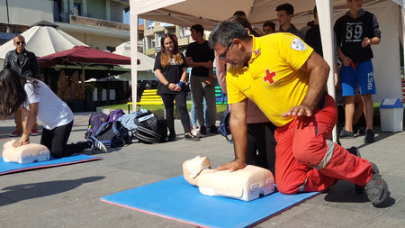 KATERINI, GREECE - OCTOBER 17 2018:  The instructor of Red Cross showing CPR on training doll on...