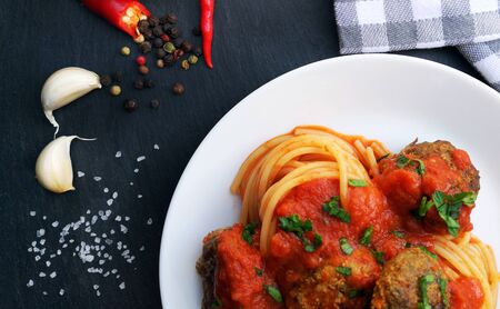 Spaghetti pasta with meatballs and tomato sauce on white plate の写真素材