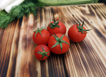 Fresh cherry tomatoes, on wooden tableの写真素材