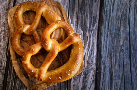 Homemade Soft Bavarian Pretzels on a wooden boardの写真素材
