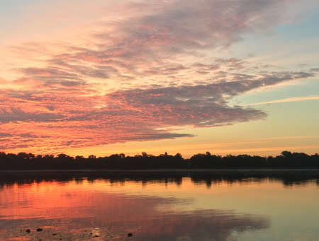 the orange summer sunrise on the riverの写真素材