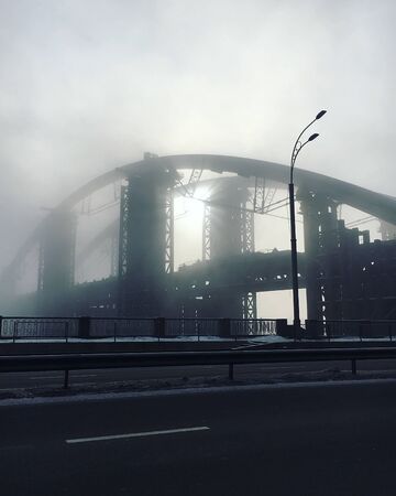 the town bridge in the fog in the rays of the sunの写真素材