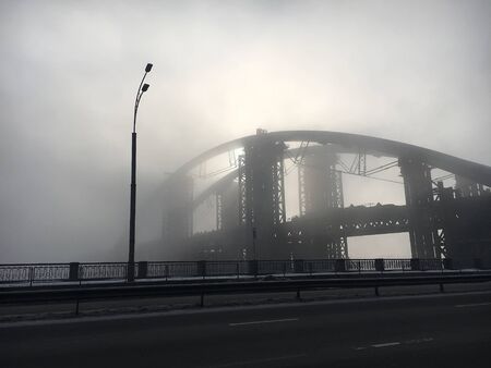 the town bridge in the fog in the rays of the sunの写真素材