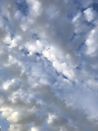 Blue sky with fluffy clouds in the spring