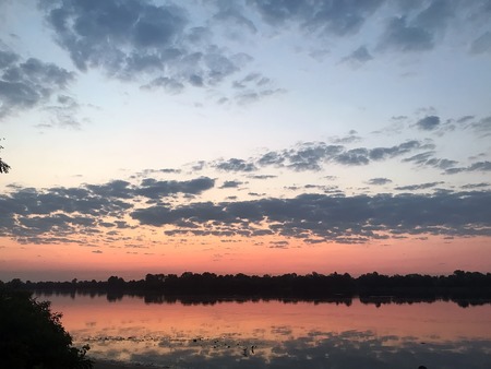 the orange summer sunrise on the river