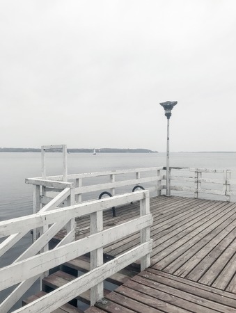 cloudy autumn gray lake in the fogの写真素材