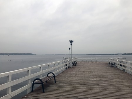 cloudy autumn gray lake in the fogの写真素材