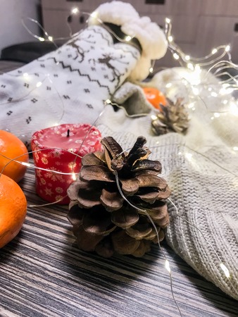 mandarins, bumps, candles and garlands on a cold winter eveningの写真素材