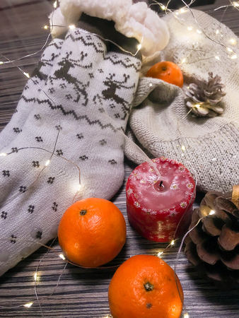 mandarins, bumps, candles and garlands on a cold winter eveningの写真素材
