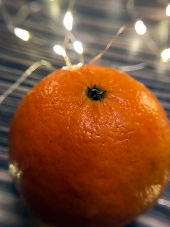 orange mandarins and garlands on a cold winter eveningの写真素材