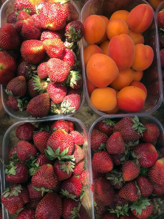 background of a lot of strawberries and apricotsの写真素材