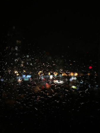 night rain drops and lights on the glassの写真素材