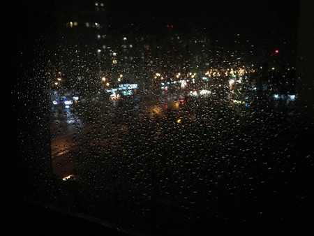 night rain drops and lights on the glassの写真素材