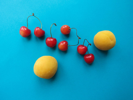 apricots and sweet cherries beautifully lie on the tableの写真素材