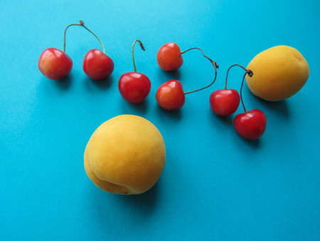 apricots and sweet cherries beautifully lie on the tableの写真素材