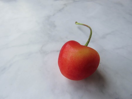 red cherries beautifully lie on a tableの写真素材