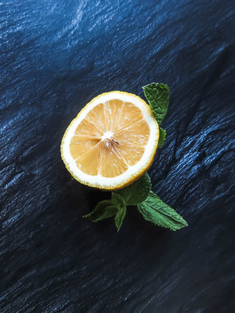 a slice of lemon and sprig of mintの写真素材