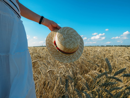 the Straw Hat in a wheat field in the Sunの写真素材