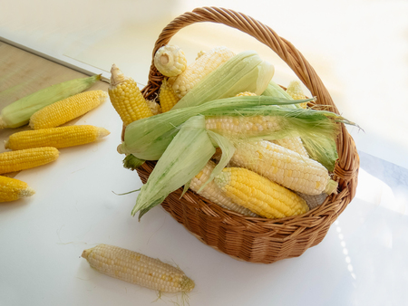 ripe natural corn cobs in a basket. healthy eating. eco-friendly products. Organic Food. Style Top View Group Objectsの写真素材
