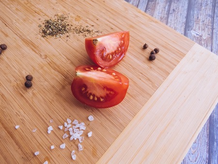 red and yellow tomatoes sliced on a wooden board. healthy eating. eco-friendly products. Organic Food. Style Top View Group Objectsの写真素材