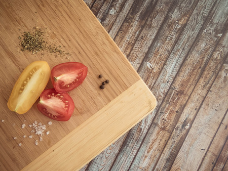 red and yellow tomatoes sliced on a wooden board. healthy eating. eco-friendly products. Organic Food. Style Top View Group Objectsの写真素材