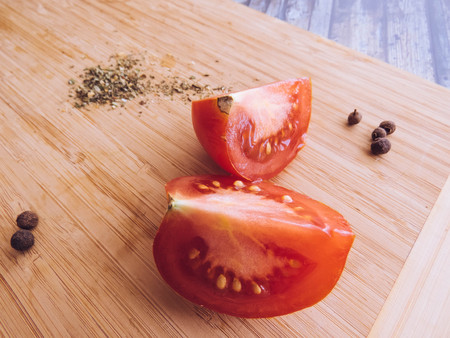 red and yellow tomatoes sliced on a wooden board. healthy eating. eco-friendly products. Organic Food. Style Top View Group Objectsの写真素材