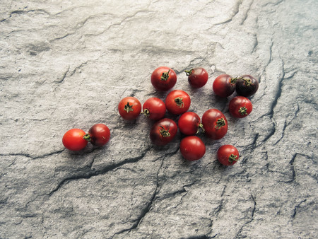 red tomatoes on a wooden board. healthy eating. eco-friendly products. Organic Food. Style Top View Group Objectsの写真素材