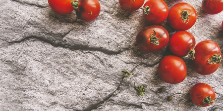 red tomatoes on a wooden board. healthy eating. eco-friendly products. Organic Food. Style Top View Group Objectsの写真素材
