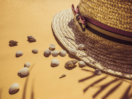 Holiday, vacation tropical beach from above - palm tree leaves and a straw hat. seashells. Style Top View Group Objectsの写真素材